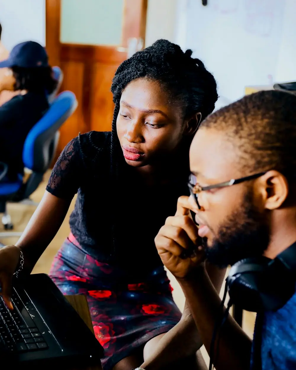 Two developers reviewing code together at a desk