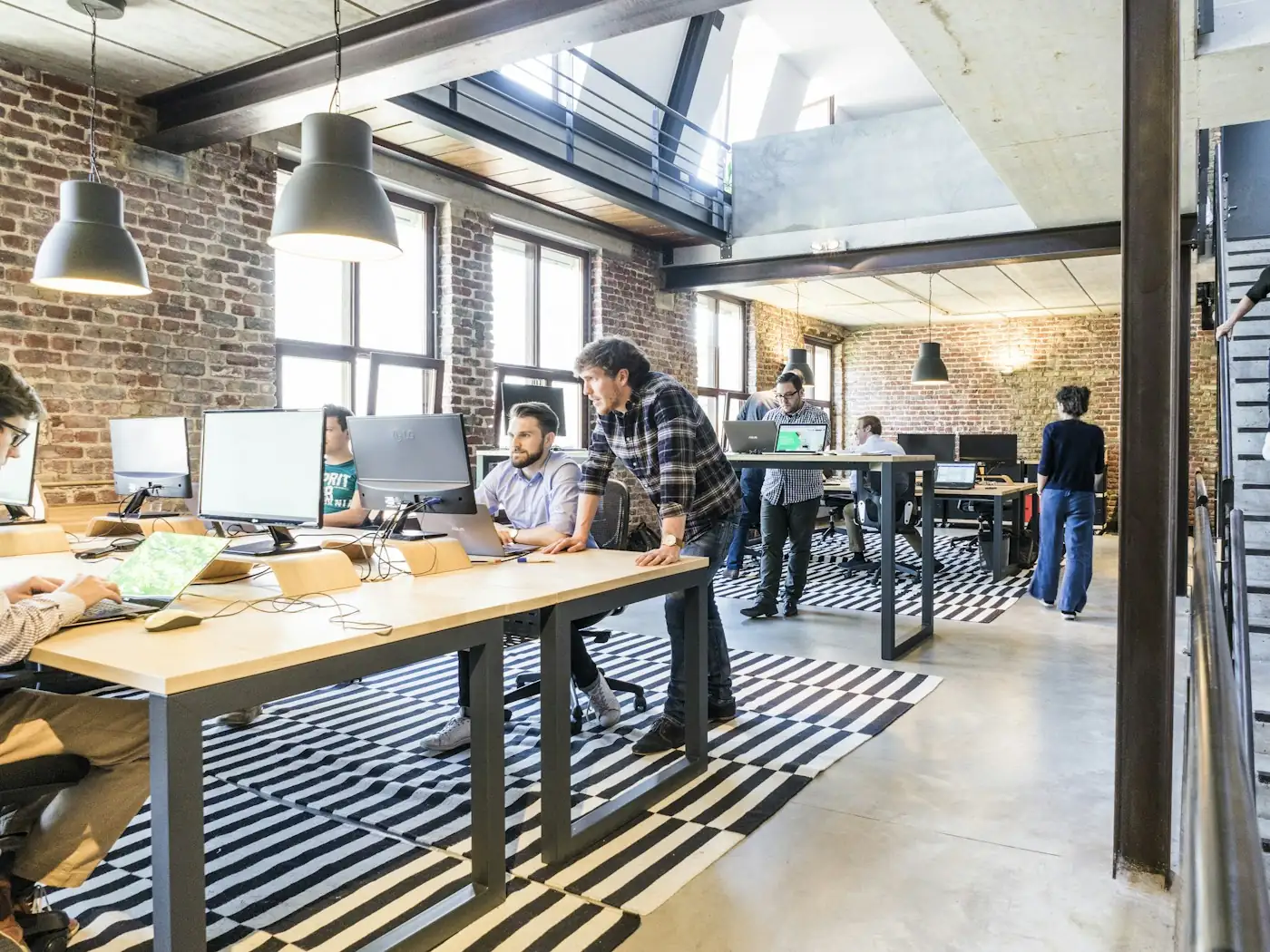 An open loft studio with brick walls and shared desks